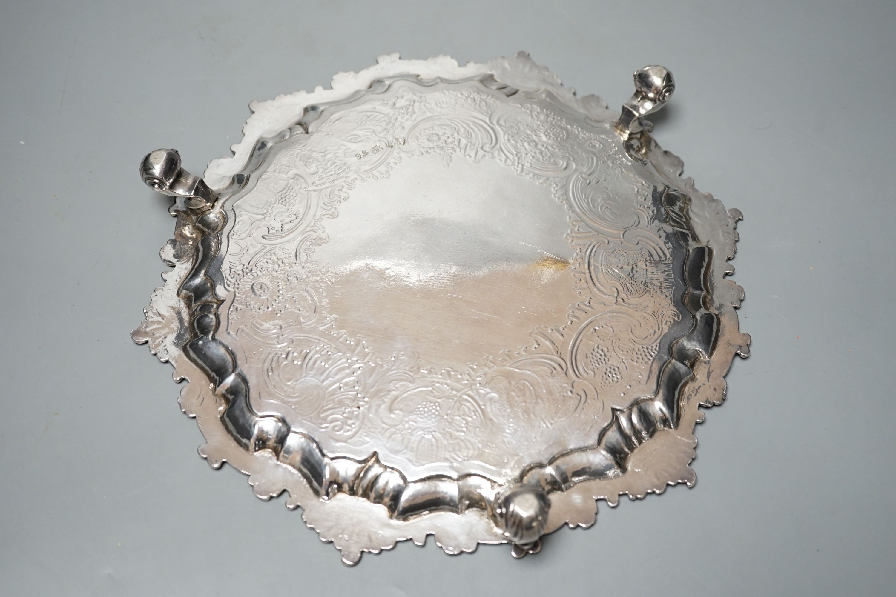 A George II silver salver, Hugh Mills, London, 1748, with later engraved decoration, 28.6cm, 25.5 oz (a.f.).